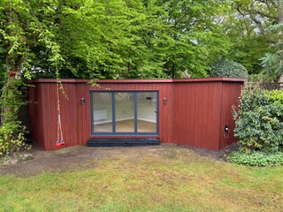 Red Board & Batten Garden Room with Millboard Jarrah Feature